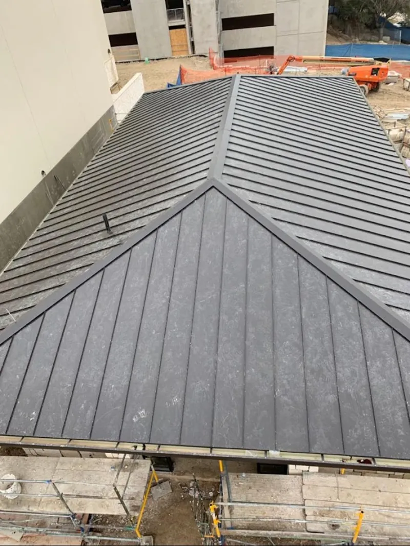Commercial metal roof construction with crane equipment in Schofield Barracks