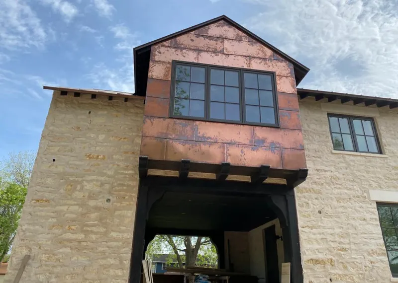 Copper metal panel facade on a stone building for Roof Repair in Schofield Barracks