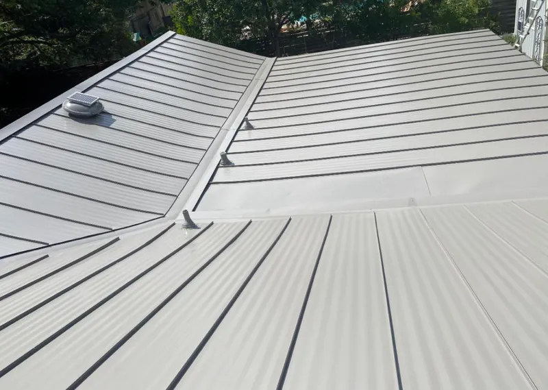 Solar attic fan installed on a metal roof for Roof Ventilation in Schofield Barracks